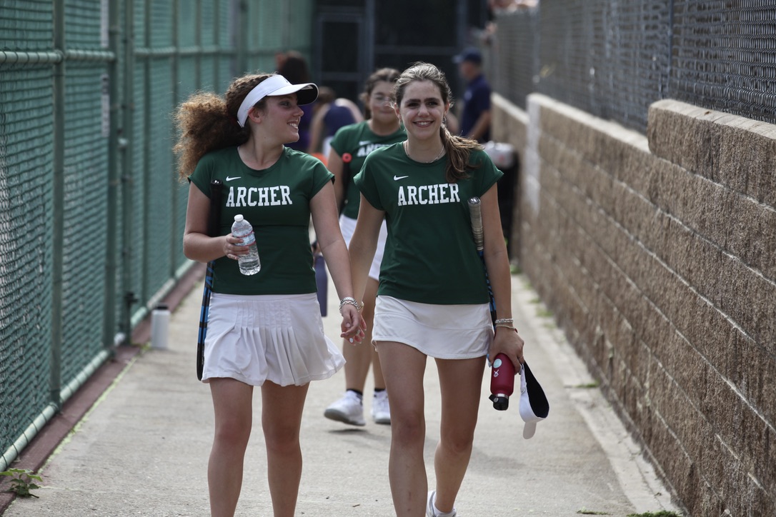 Team captains Stephanie Harrison (24) and Emi Marmol (24) chat as they come off the court. The JV tennis team had a final record of 8-1. Photo by Archer Athletics. 