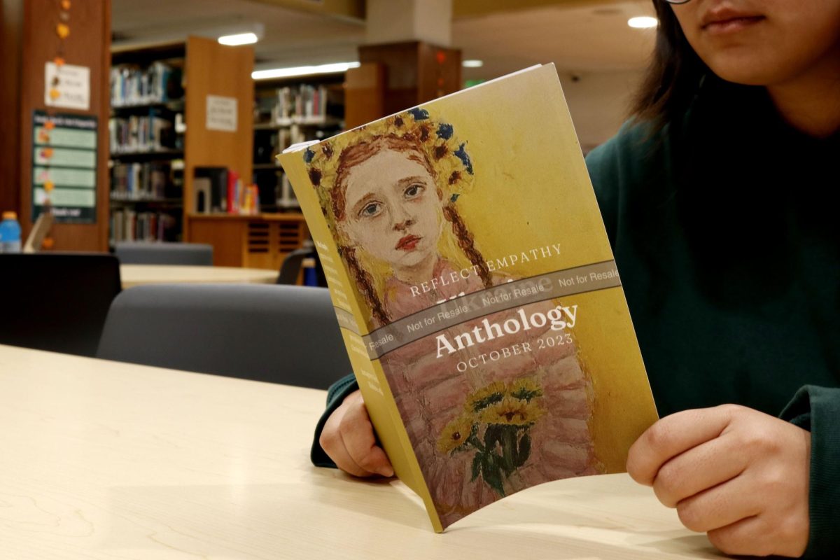 Sophomore Melinda Wang reads Reflect Empathy Ukraine Anthology in the library. She and sophomore Shayl Khatod, who attends Santa Monica High School, published their book Oct. 21 and said they hope it spreads awareness about the humanitarian crisis Ukraine continues to face. 