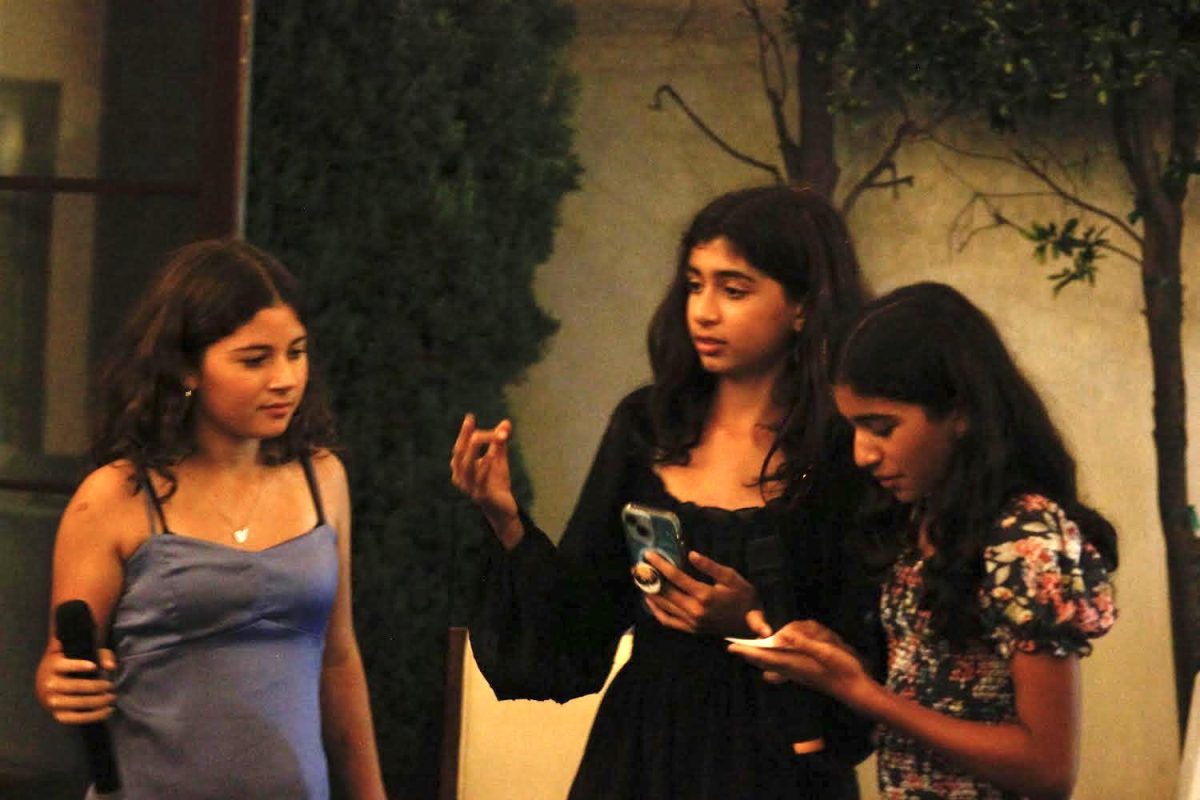 Eighth graders Phoebe Miro, Leani Al-Midani and Nissara Shah give a speech about child marriage in the U.S. and the world at their VOW for Girls fundraiser Friday, Oct. 20. The girls shared statistics about the occurrence of child marriage and educated their fellow eighth grade attendees about the dangers associated with it. Photo by Miya Nambiar.