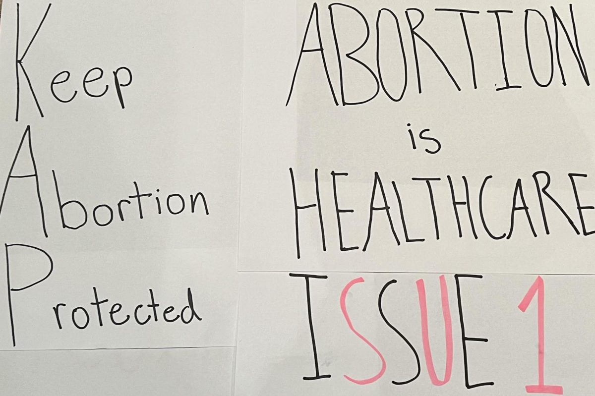 Signs are displayed featuring phrases in favor of abortion protections and affirming a woman’s right to an abortion. Although Ohio’s passing of Issue 1 is important in re-securing reproductive freedoms across the U.S., it is hard to not feel disappointed that we must re-secure these protections in the first place.