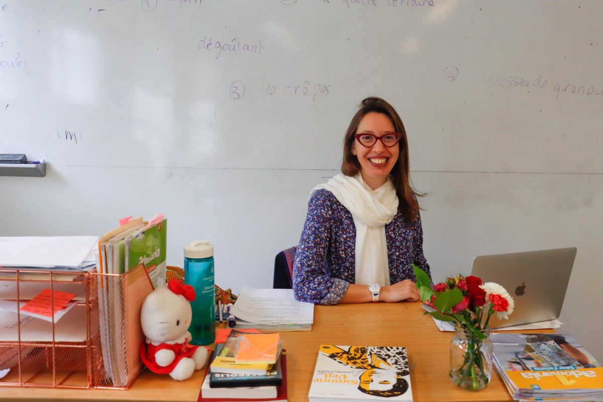 French teacher Laurence Clerfeuille sits at the desk in her classroom. She currently teaches French 1B and French 3 Accelerated. “I’m lucky,” Clerfeuille said. “I don’t think any one can love their job as much as me.”