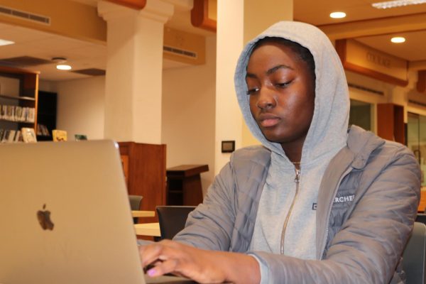 Dara Alitoro (‘28) writes on her laptop in Archer’s library, a place where she does a lot of her schoolwork and writing. Alitoro recently wrote about her personal experiences with racism in an acrostic poem. After reading her poem, English teacher Sala Bandele-Jackson said she was proud of Alitoro for being honest and candid.