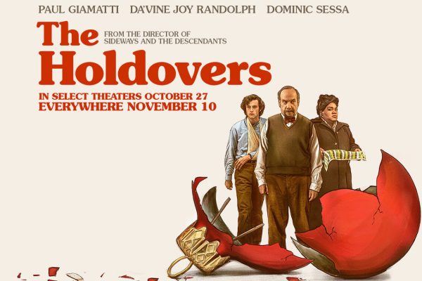 Surrounded by shards of glass, Angus Tully (Dominic Sessa), Paul Hunham (Paul Giamatti) and Mary Lamb (DaVine Joy Randolph) stand behind a broken red Christmas ornament. Set in 1970, The Holdovers follows strict history teacher Paul Hunham as he is forced to supervise students who have nowhere to go over the winter break. The film centers on the growing bond between Hunham, Tully and Lamb.  Photo Source: Image from  The Holdovers on IMDb 
