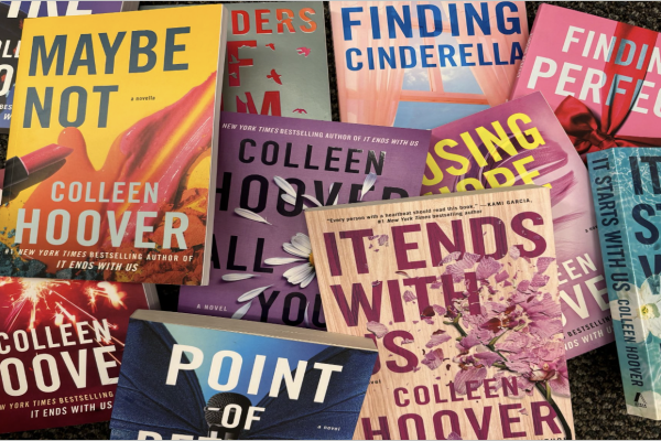 Colleen Hoover’s candy-colored books are displayed. The popular author writes predictable, twisted love stories that advertise harmful and unhealthy habits and relationships to her young adult readers.
