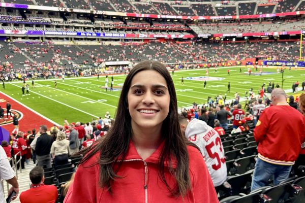 Wearing red for the San Francisco 49ers, Danika Jhawar (24) poses in front of the field at Allegiant Stadium. She attended the 58th Super Bowl Sunday, Feb. 11. 