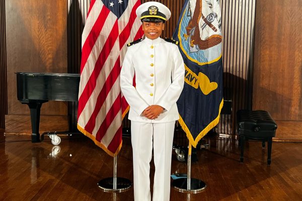 Gabrielle Cain stands at her graduation in Naval Academy outfit. She graduated from flight school and became a Naval Aviator in 2023. Photo provided by Gabrielle Cain. 