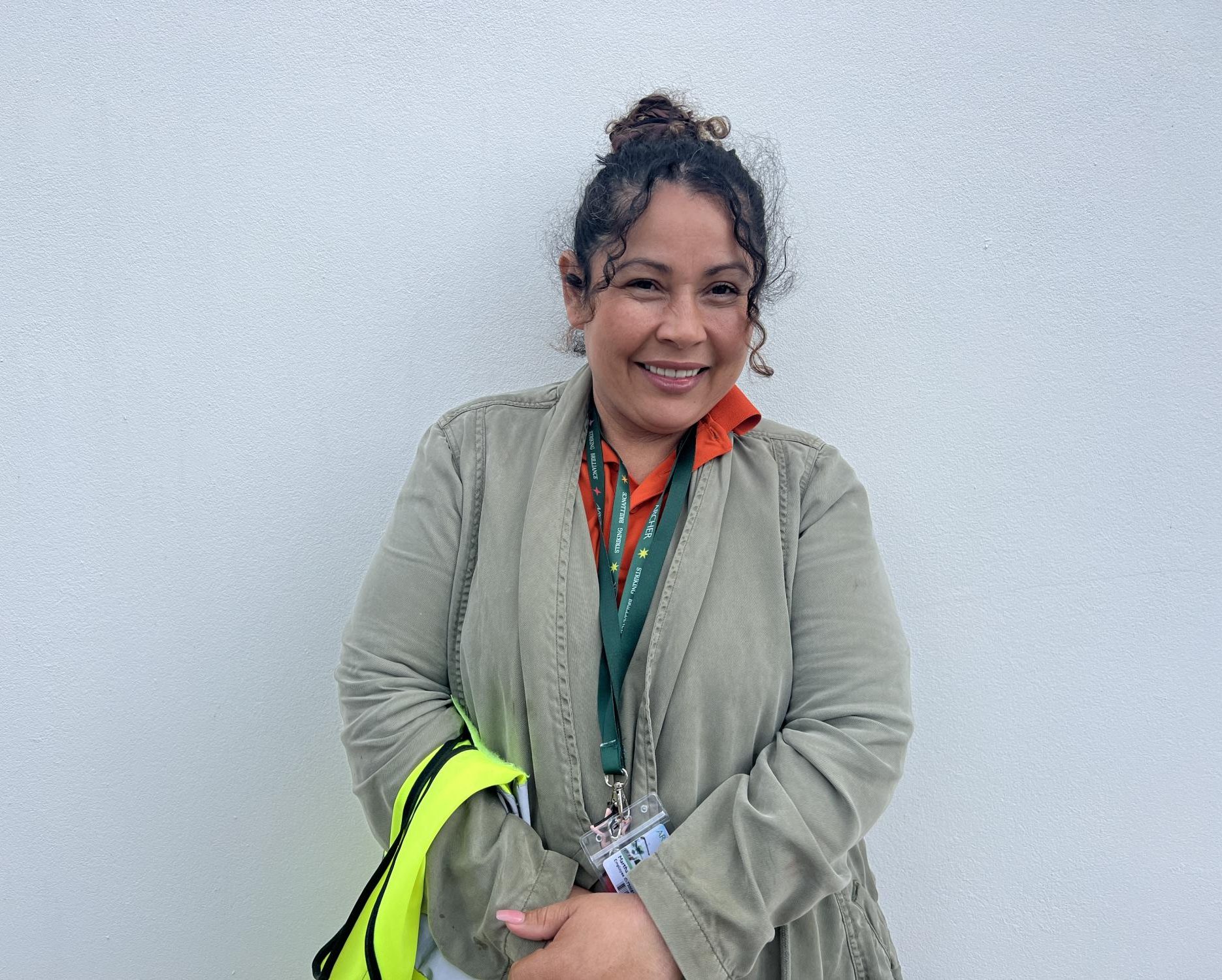 Facilities staff member Martha Sorto poses while on security duty in the north parking lot. She said her job in a diverse all-girls environment has been a new and exciting experience.