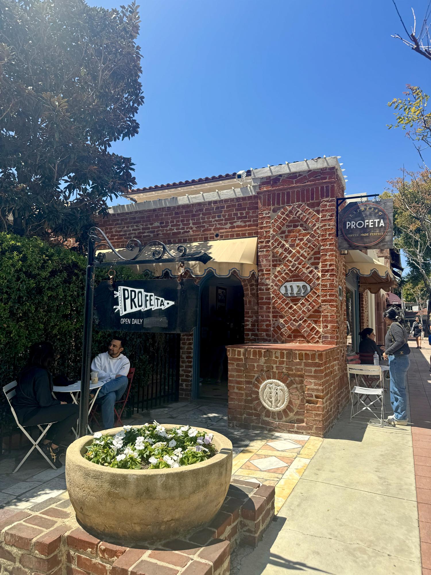 Cafe goers enjoy their drinks and pastries in front of Espresso Profeta. Not only does Espresso Profeta offer delicious drinks and pastries, but it also provides a beautiful outdoor courtyard to enjoy your goods. 