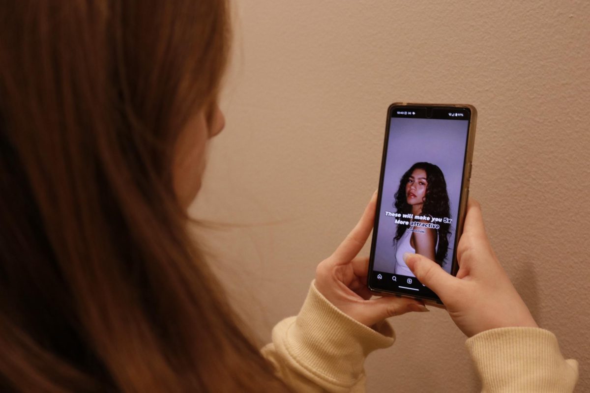 A student views a video on instagram that gives tips to “make you 5x more attractive.” Videos like these can be found across social media and encourage viewers to change their appearance or actions to fit within beauty standards.