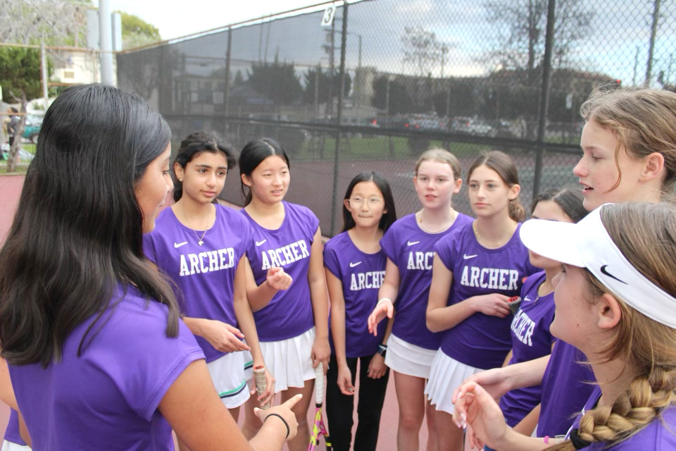 The middle school purple tennis team gather in a circle to prepare before their match against Windward, March 7, at Mar Vista Park. The team lost in the second round of CIF playoffs May 1. “We lost, but we’ve put up a fight,” Maggie Collins (’28) said. “I think that’s what really matters.” Photo courtesy of Archer Athletics.