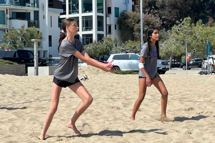 Members of the middle school beach volleyball team practice at the Annenberg Beach. The team is composed of 15 total players. Only three pairs play for points in tournaments, and alternates play for fun against other teams. “Im having fun and definitely gaining skills and confidence on and off the court,” Bella Sklaver (‘29) said. “I feel like thats a lot of what sports is all about.” Photo by Sheila Micelli.