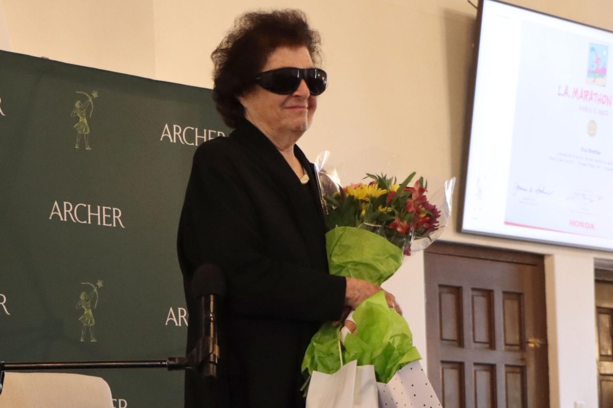 Holocaust survivor Eva Brettler receives flowers and gifts as a form of gratitude from the Jewish Student Union. Brettler came to Archer Monday, April 15, and spoke to the community about her experience during the Holocaust.