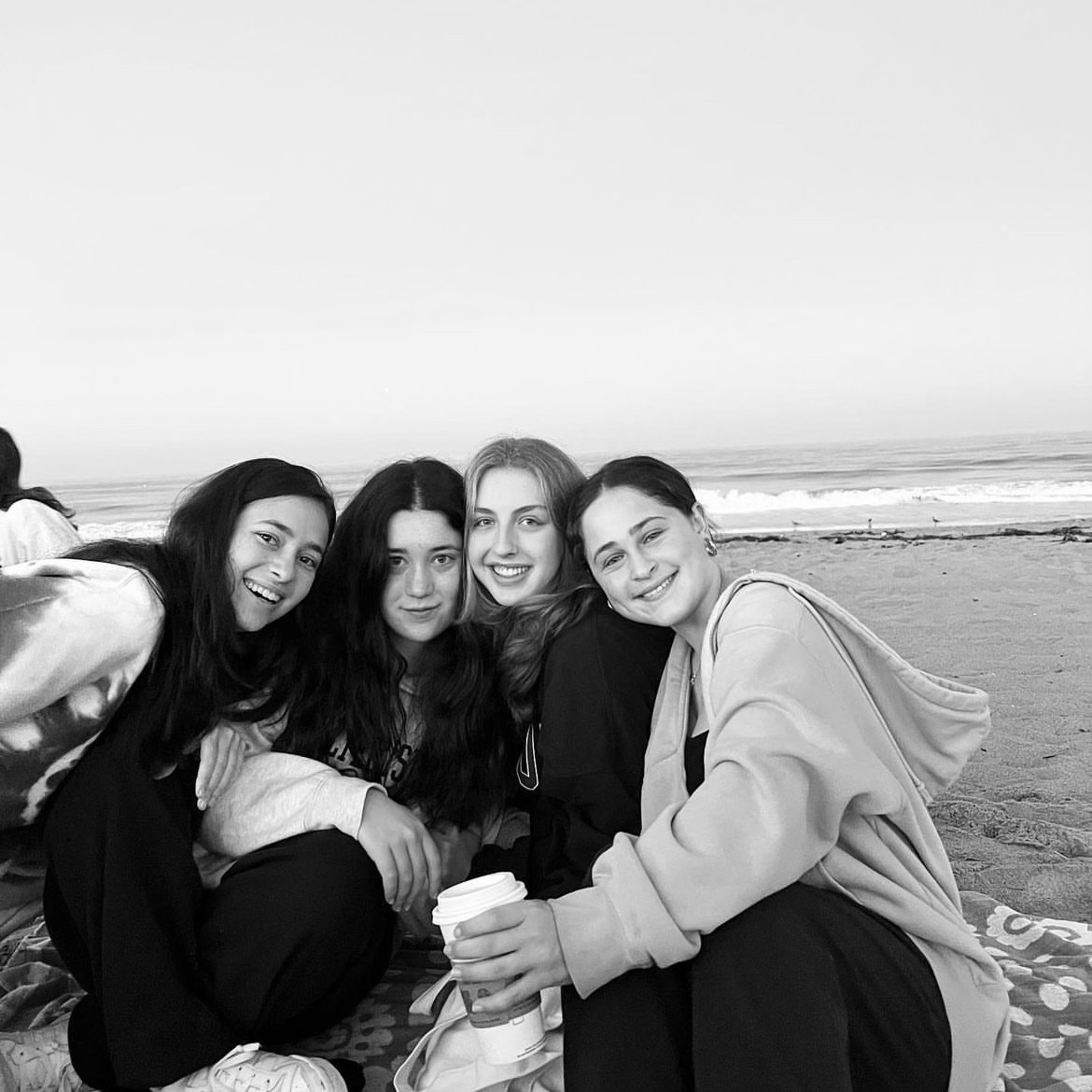 Seniors Sydney Azar, Alex Martin, Sophia Landers and Anna Entin sit at the beach for their senior sunrise. Before the school year started, the senior class planned a sunrise at the beach together and closed out the school year by having a senior sunset. (Photo courtesy of Sydney Azar)