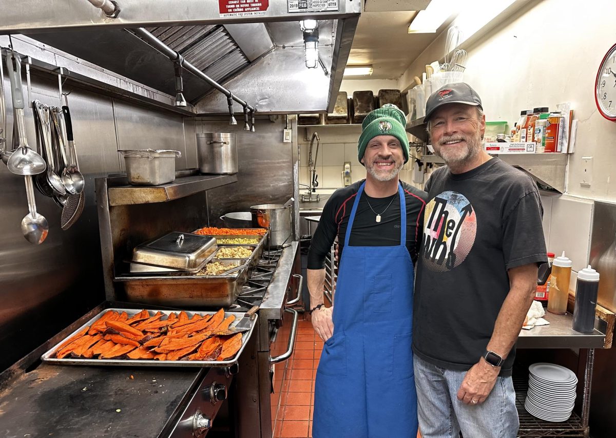 Chef James Cunningham stands with Jack Watkinson in Bread and Roses kitchen. Bread and Roses cafe feeds over 200 people daily. 