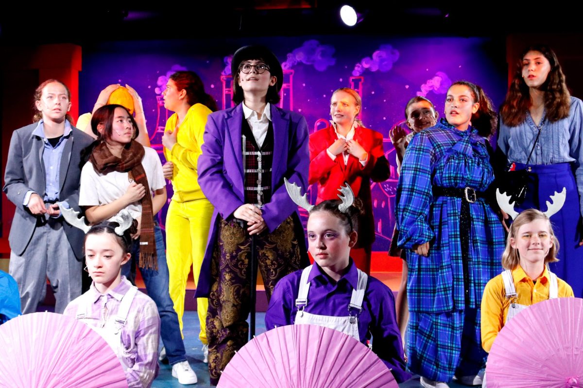 Middle school students in Willy Wonka look out into the audience while singing Theres No Knowing. Archers productions of Willy Wonka occurred May 16-18 in the Blackbox Theatre.  