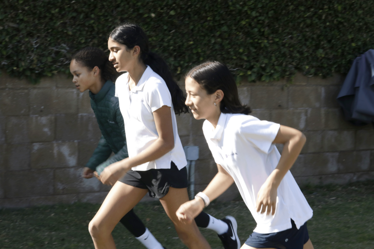 Jenna Ogoke (29), Nissara Shah (28) and Lila Sheehy (30) run up the backfield during practice. On Tuesdays and Thursdays, coaches hosted practice at Archer, where the team started with a warm up and then moved onto a set of sprints. On a particular practice day, athletes ran a set of eight 200-meter sprints with short breaks in between.
