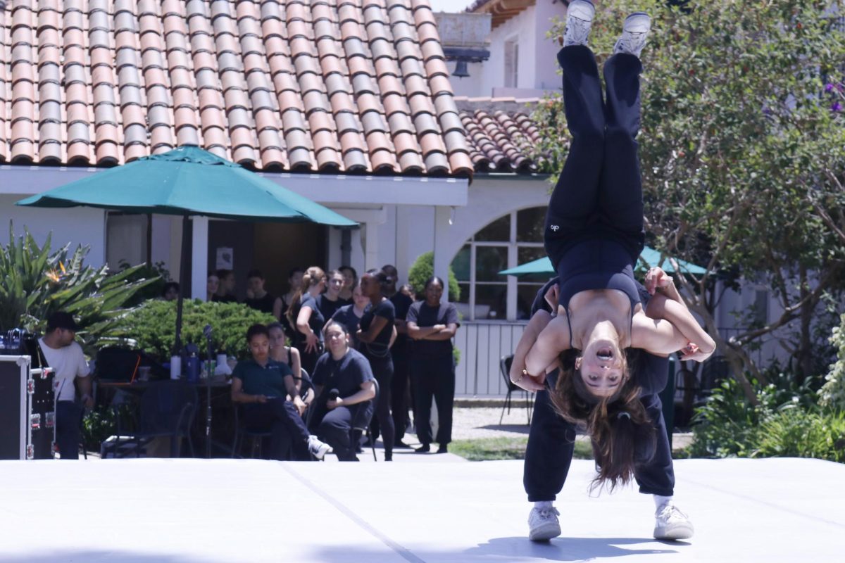 Frankie Scott (27) flips over Alex Sunshine (27) in their self-choreographed dance titled Private Landing. This years Festival of Dance took place, May 9, in the courtyard and featured 21 original choreographies and 59 dancers.