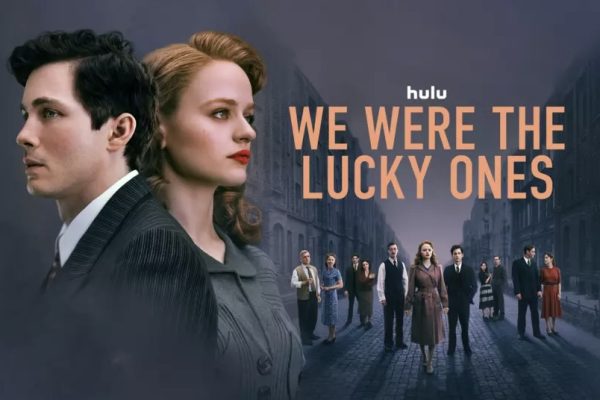 A poster depicts Addy (Logan Lerman) and Halina (Joey King) Kurc looking off into the distance, as well as the Kurc family standing in a street in Radom, Poland. We Were the Lucky Ones follows the Jewish Kurc family as they are separated at the beginning of World War II and attempt to reunite once again. We Were the Lucky Ones promotional poster courtesy of Hulu.