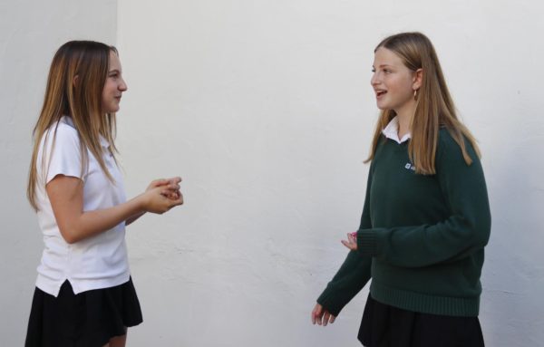 Immersed in song, sophomores Olivia Broock and Lena Sakhnini prepare for upper school musical auditions in the RBG courtyard. Auditions took place Tuesday, August 27, and the cast list was released Saturday, August 31. 