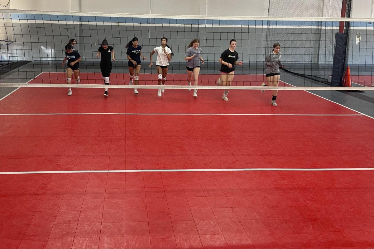 Archer varsity volleyball players run laps at a warm-up during practice Sept. 4. The team practices for two hours after school at Vertical Sports Performance. Several sports practice off campus, such as tennis and cross country. 