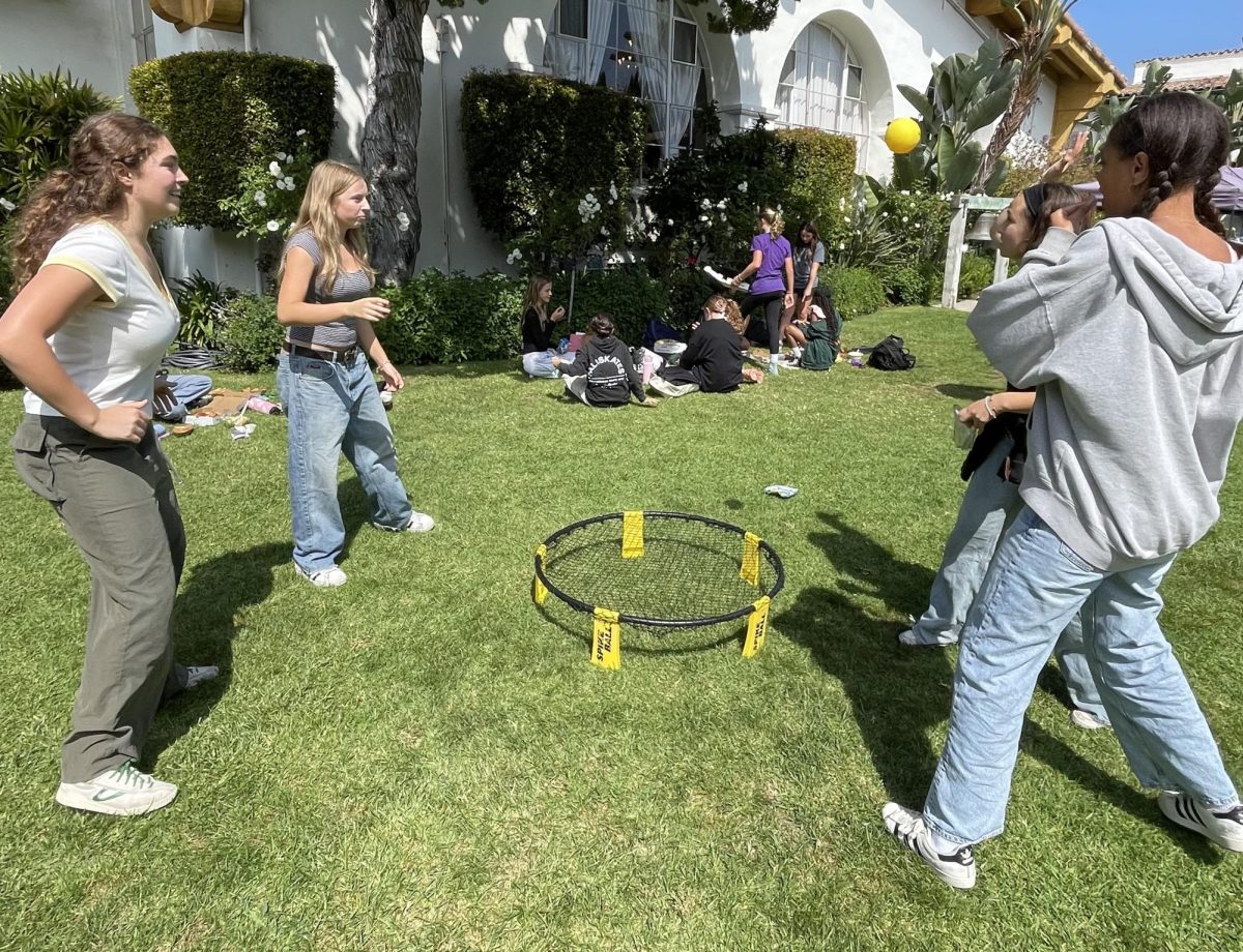 Juniors Caroline Collis, Cleo Wilson, Julia Ong and Dakota Tooley play spike ball during the first Final Friday of the year. The Final Friday celebration was summer-themed and occurred Friday, Sept. 27. 