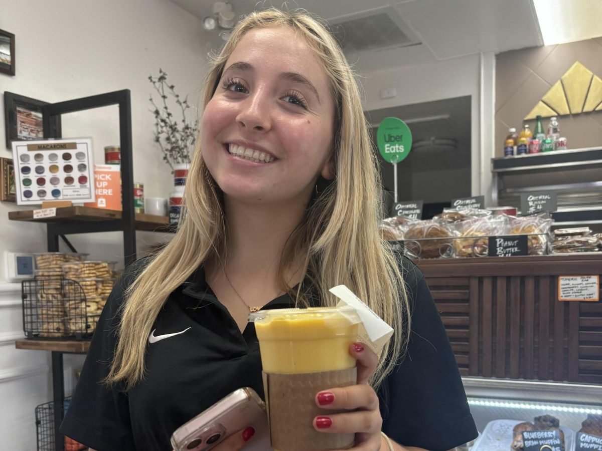 Autumn Walker ('27) poses with her mango smoothie from Belwood Bakery during lunch Tuesday, Sept. 24. "Belwood has fantastic smoothies, if I need a sweet treat halfway through the day," Walker said.