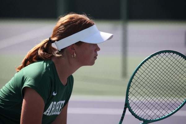 Poised and ready to play, JV tennis team captain Avery Panepinto (‘27) grips her racket. This year is the team’s first in the Gold Coast League, and they have won the majority of their matches. Photo by Archer Athletics.