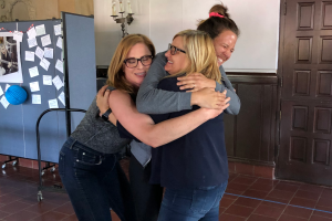 English Department Chair Wendy Deming and Ninth Grade Dean of Culture, Community and Belonging Stephanie Ferri hug Pavilscak as they celebrate her promotion to Associate Head of School for Teaching and Learning in 2019. Photo courtesy by Stephanie Ferri.