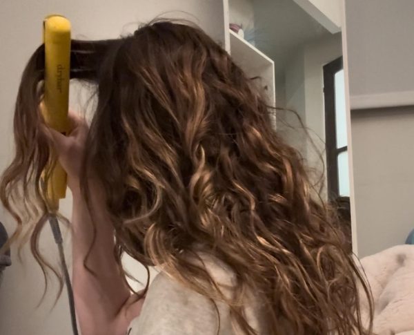 A girl straightens her naturally curly hair. Hair straightening has become routine in many girls' lives. Constantly straightening our hair changes how we see ourselves and can have lasting negative impacts on self-esteem. 