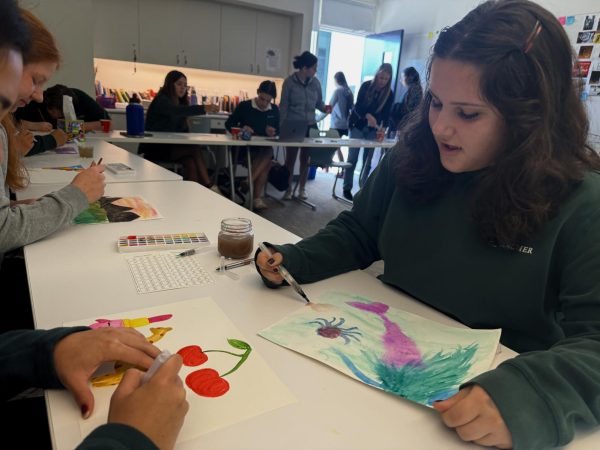 Senior Charlie Clayton paints a mermaid using watercolors. This activity was a part of the "challenge-by-choice" workshops offered to all seniors during M&M time Nov. 18. The workshops were intended to provide a space for the seniors to destress amidst the stressors of senior year.