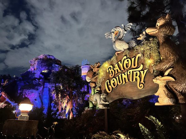 Illuminated by bright yellow lights, a 'Bayou County' sign stands in front of Disney's new ride called Tiana's Bayou Adventure. Due to Splash Mountain’s racist and outdated theming, Disney transformed it into Tiana's ride. 