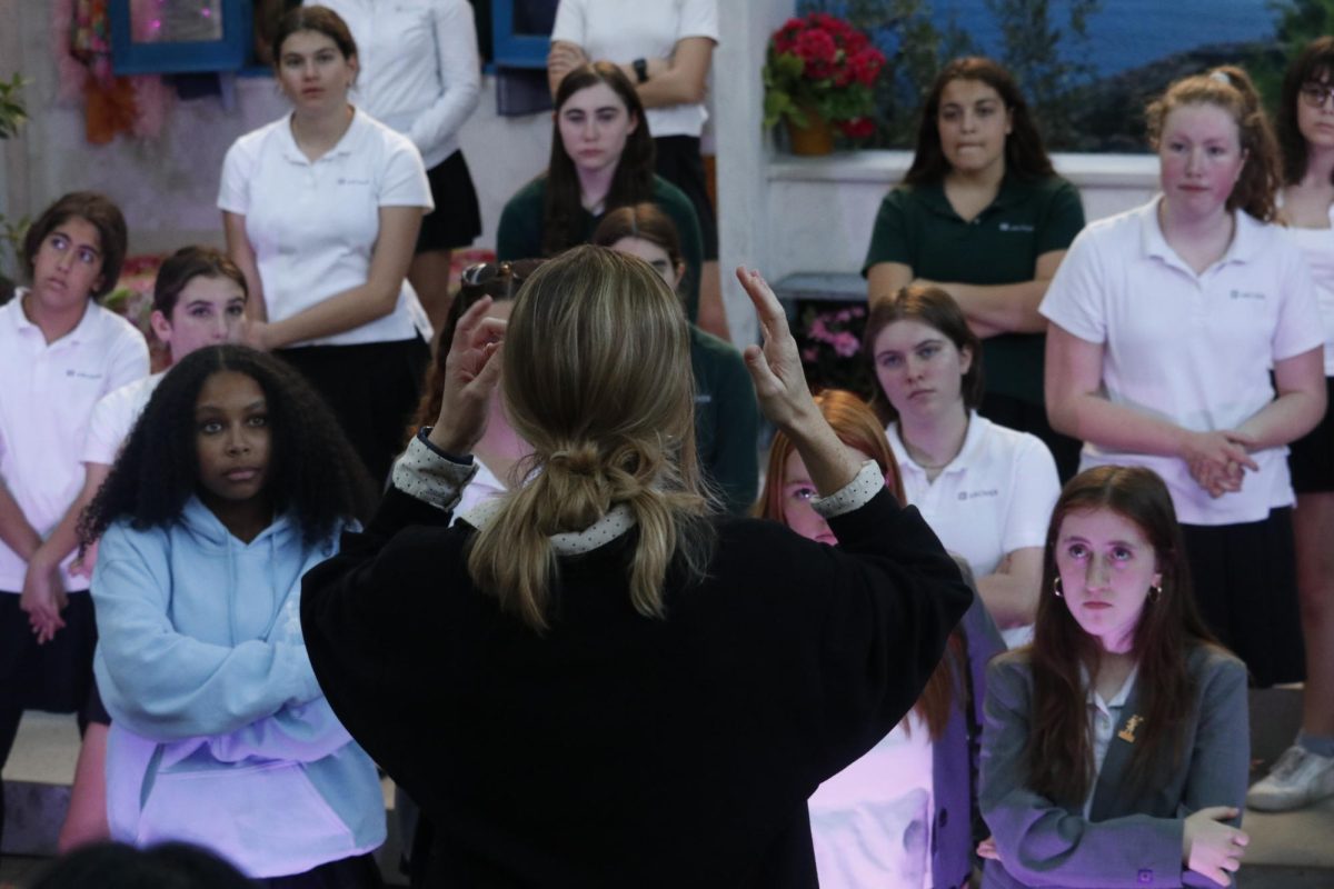 Musical director Samara Kelly gives students notes during tech week. Assistant director Grace Whitney said she is grateful to have the experience of assisting the directing process. "We're very lucky in the upper school, to work with people who are so committed to you know, making it the best show it can be. And no matter what role they have, which I think is a rare thing, especially in high school," said Whitney.