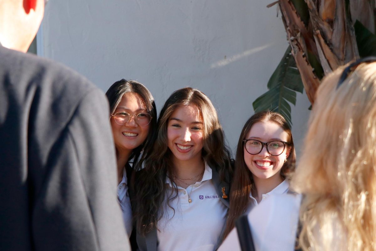 After the ceremony, Natalie Huang ('25), Lily Poon ('25) and Addie Meyers ('25) pose to take a picture. Many seniors took pictures with their family and friends after the ceremony to capture moments during Founders Day. "A moment that I enjoyed is right after Founders Day, when a lot of seniors were taking pictures," Curry said. "They were kind of doing things [to] soak up those last Founders Day memories. Because even if we forget what was said during the speeches, and even if we forget everyone who was in our class, who will forever have those pictures, and those will be cemented memories."