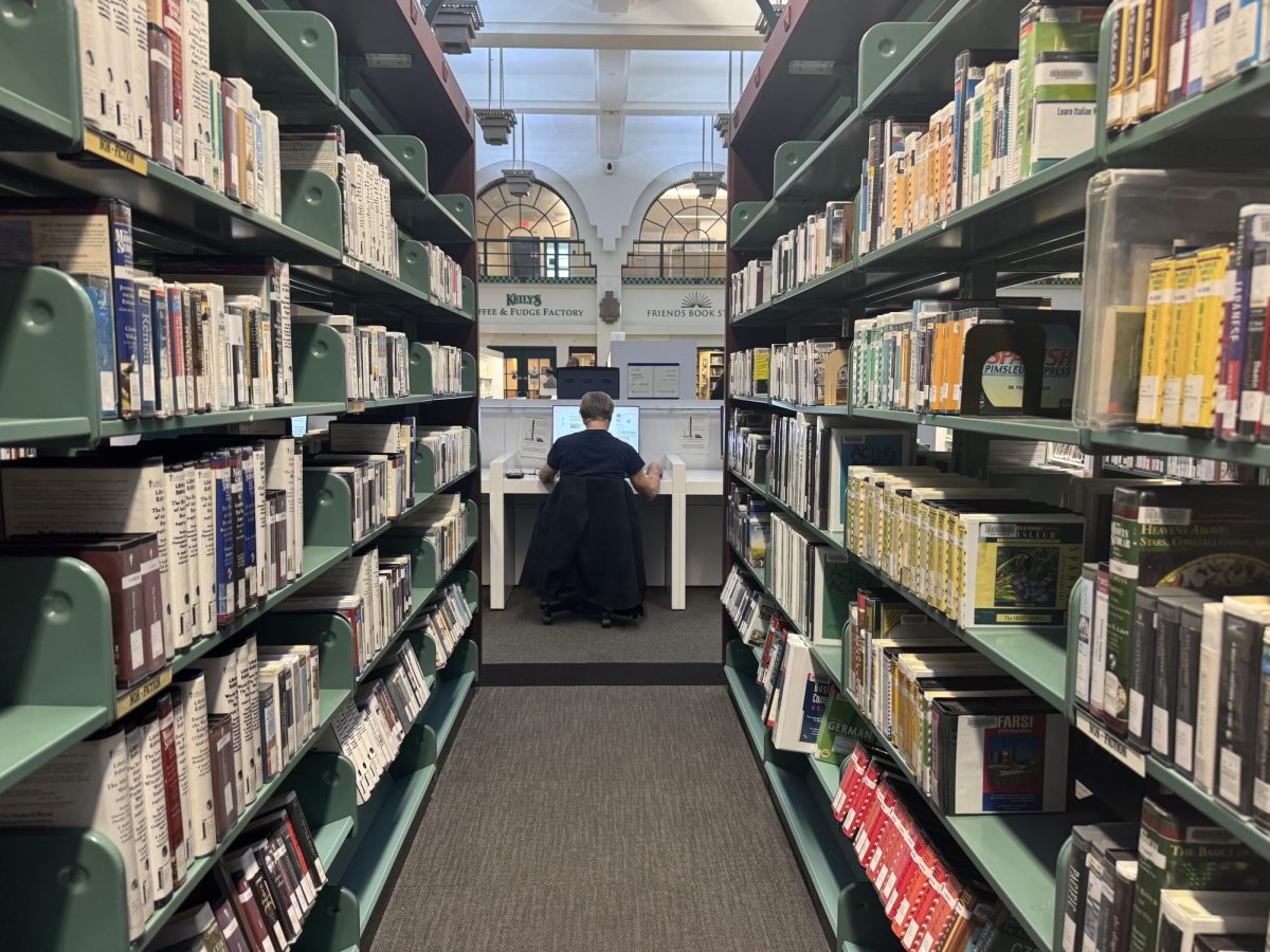 A library goer at the Beverly Hills Public Library sits at a desk doing work. Many seniors among the class of 2025 have begun attending their local public libraries, embracing these spaces to complete work. 