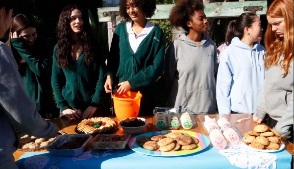 Members from the senior class stand behind their table at the bake sale. Fa La La Friday took place Friday, Dec. 6, and was aimed at raising money for the junior and senior prom this April. 