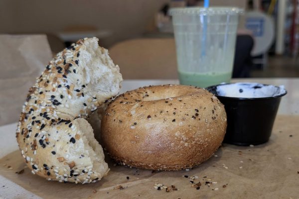 Two bagels and a container of cream cheese sit on a table. Bagels are one of the best ways to start the day, and three of my favorite spots to grab a bite to eat from are Belle's Bagels, Courage Bagels and Calic Bagel.