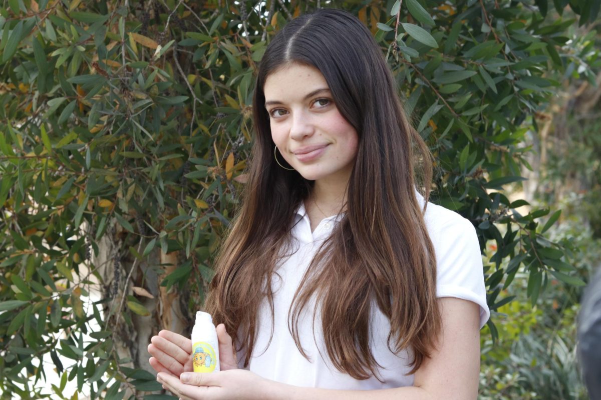 Founder of Have Fun in the Sun, Pasha Selig (‘27) holds up a bottle of sunscreen, adorned with her logo. Selig said she understands that with the help of sun protection, she is able to reduce the risk of skin cancer in her community. “As I became older and older,” Selig said, “I realized skin cancer is very much preventable, it’s 94% preventable”.