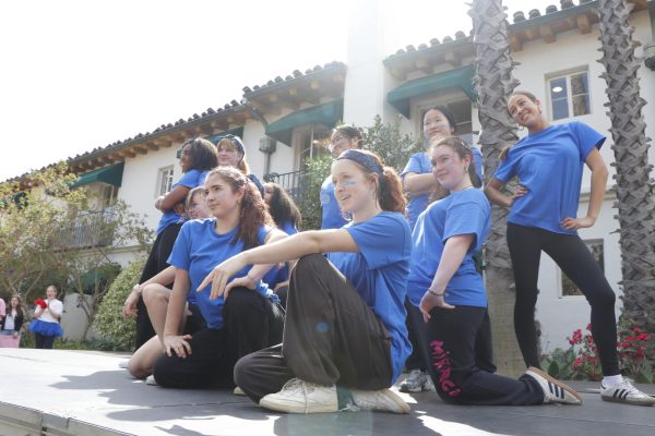 Juniors dressed in blue pose at the end of their Spirit Week dance. Junior Olivia Hallinan-Gan said performing was a great way to connect creatively with her fellow classmates. "I got to choreograph with my peers, and it helped create a sense of community within our grade," Hallinan-Gan said.