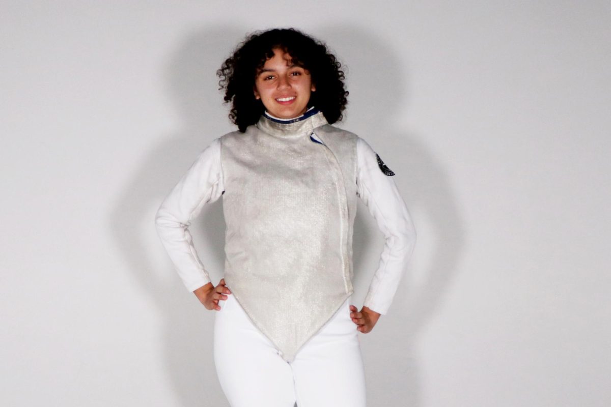 Ava Lucas ('29) poses in her fencing uniform. She has been fencing since 2020 and has become a nationally ranked fencer for her age group. Lucas said that "the fencing might not always be fun, but going on a trip for fencing might be fun or the winning might be fun."