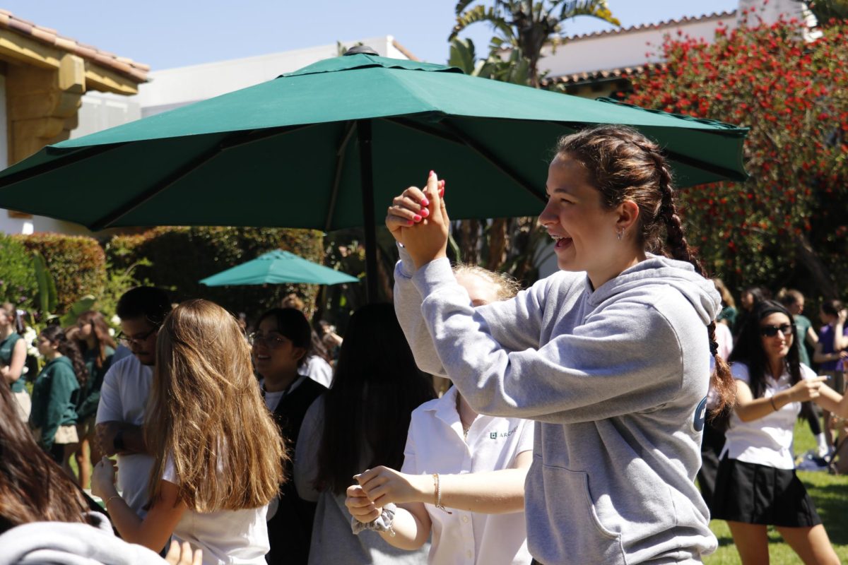 A student claps to celebrate the athletes onstage. Smith said pep rallies are a way to teach students the value of recognizing their peers. "And really, for those [who] don't know what it means to be a part of the pep rally, what does that look like? [They may ask,] 'how do I support?' 'What do I say?' 'What do I do?,'" Smith said. "So, it's really teaching the community how to celebrate the athletes."