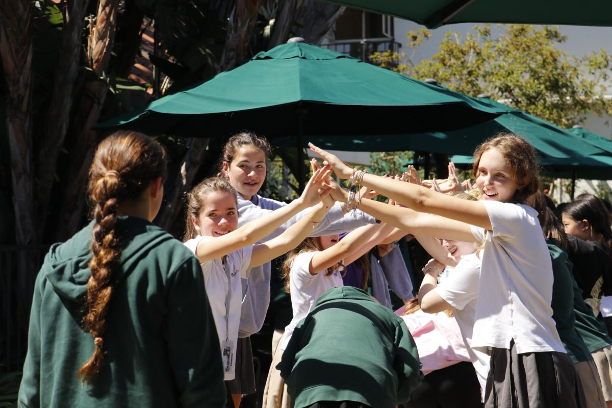 Lining up in two rows, students form a tunnel for athletes to run through. While Director of Athletics Kim Smith works with Athletic Leadership Council to organize pep rallies, she brought the idea of the student tunnel to pep rallies through her own initiative. As a member of the middle school tennis team, Juliet Park ('31) said her favorite aspect of the event was going through the tunnel — even more than other aspects like being recognized onstage or the dance.