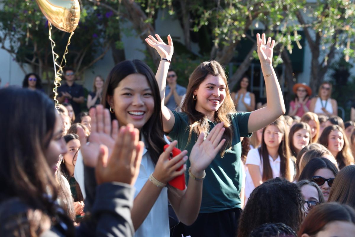 Student Council members Sydney Lem ('28) and Evan Weingarten ('26) stand and wave as Salehi spotlights them during her welcoming speech. Ninth grade class representative Lucy Bohn said that while summer went by quickly, she felt it was time to be back at school and focus on her aspirations for the new year. "I hope to get some of the goals that I set as a student council member done," Bohn said," so I can show that I made an impact this year." 