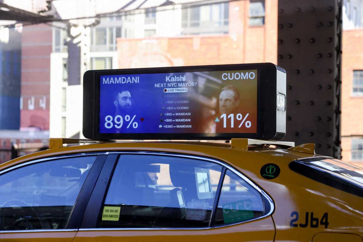 A gambling advertisement with images depicting Democratic candidate for New York City mayor, Zohran Mamdani, and independent candidate Andrew Cuomo, is displayed on top of a taxi during the New York City mayoral election, in New York City, U.S., November 4, 2025. REUTERS/Kylie Cooper