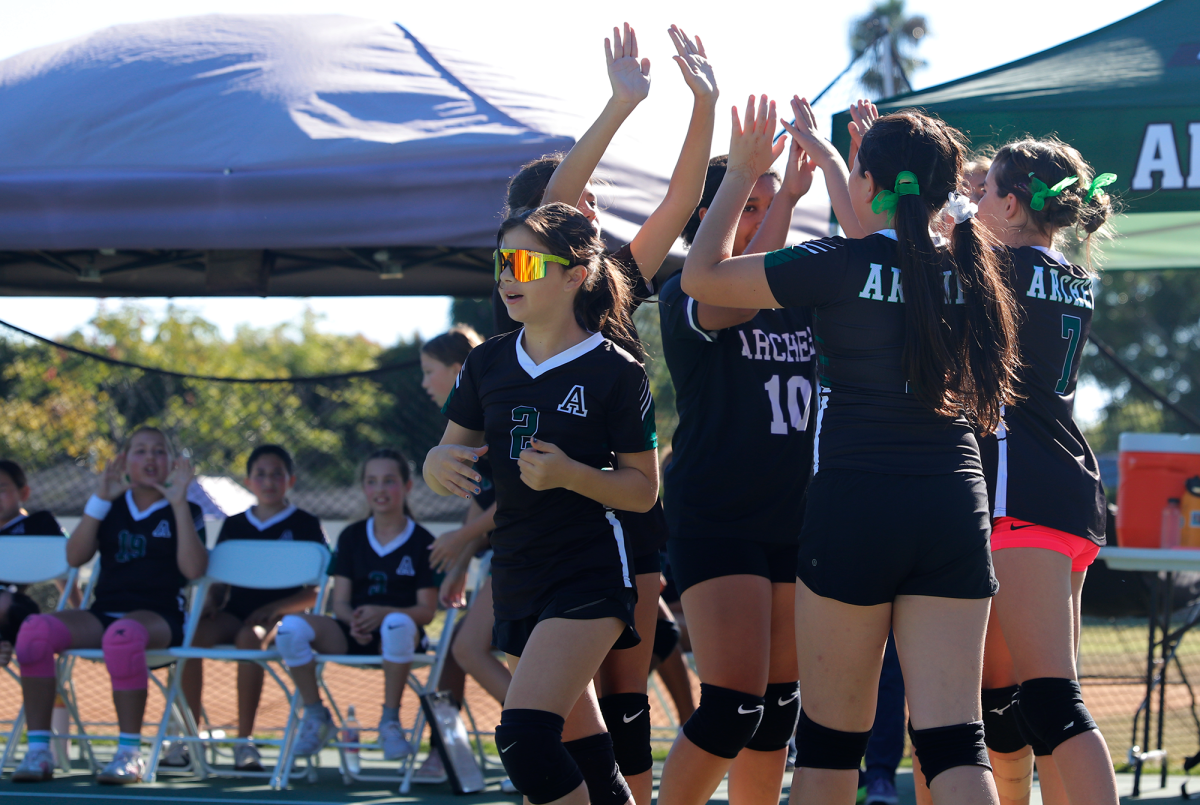 Huddling up, middle school volleyball athletes lead a cheer after a timeout is called. They played an intense game against the Lighthouse Christian Academy Saints, but they ultimately lost 2-0.