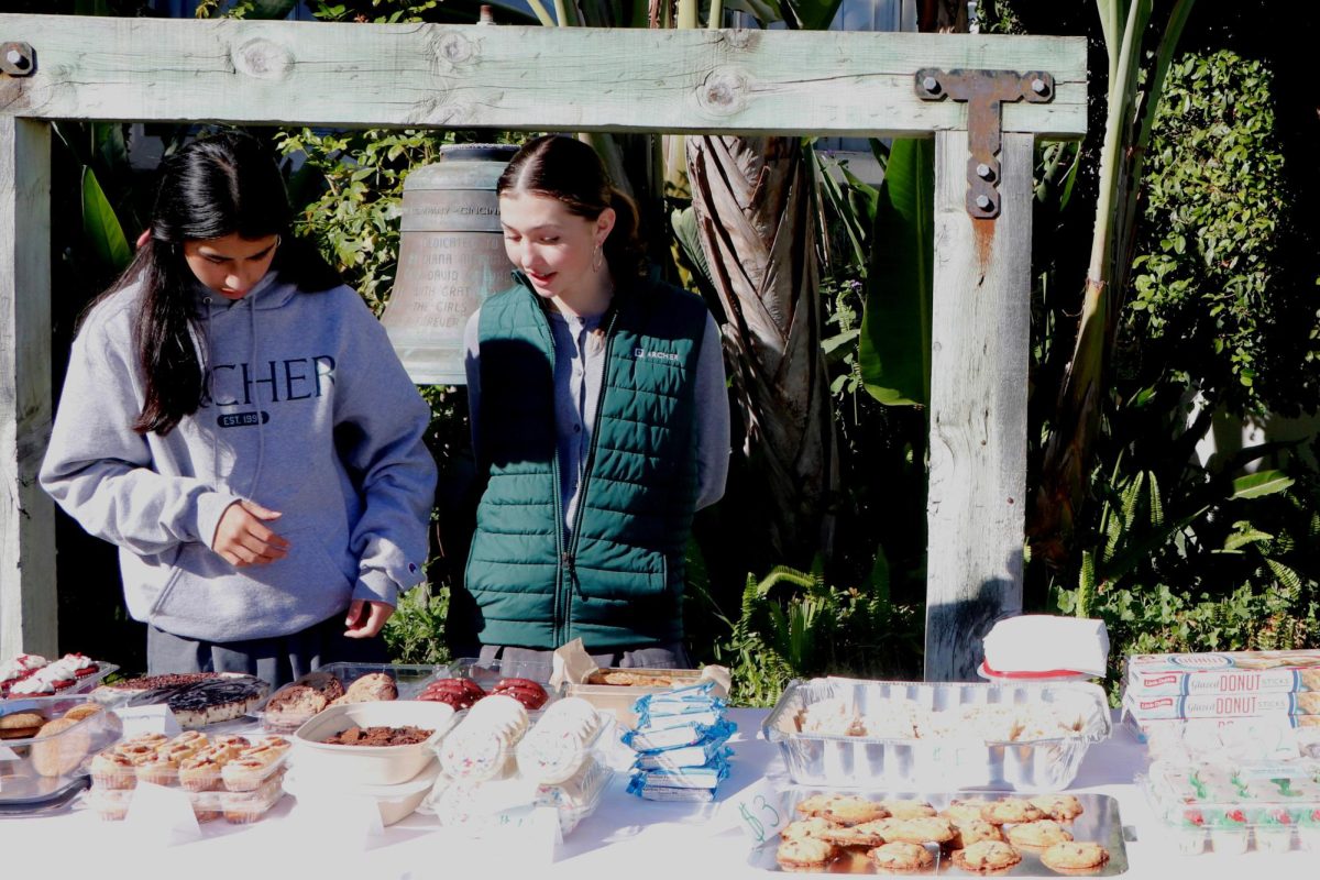 Alba and Jacobson wait to help serve Archer students at the bake sale. Alba said ever since she was little, she had a desire to help vulnerable communities. "My favorite part of the fundraiser was watching so many people in the Archer community come together to support The Children's hospital of Los Angeles," Alba said. "I find it shocking how much a few cookies can help impact kids in need."