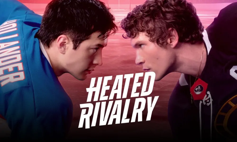 Connor Storrie stares intensely at Hudson Williams on a hockey rink. Heated Rivalry follows the romance between Ilya and Shane as they explore what it means to be queer in the early 2000's. (Promotional image courtesy of Crave)