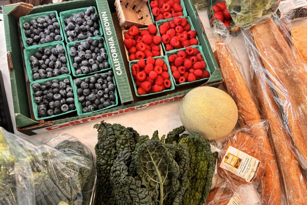 Fresh produce from the farmers market is displayed on a kitchen counter. Shopping at the farmers market is a great way to buy seasonal foods and support the environment. 