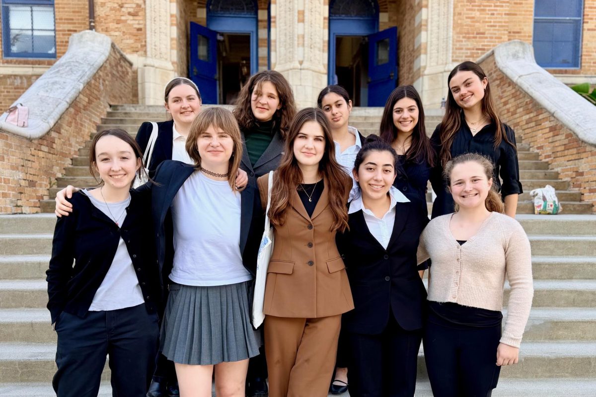 Archer's Speech and Debate team stands on the steps of University High School, ready for their tournament. Sophomore Sarah Mzougi said speech and debate not only builds bonds within the team, but also confidence and agency. “I think speech and debate have made me a much more confident person,” Mzougi said, “and for that, I owe it so much, I owe the club so much.” 