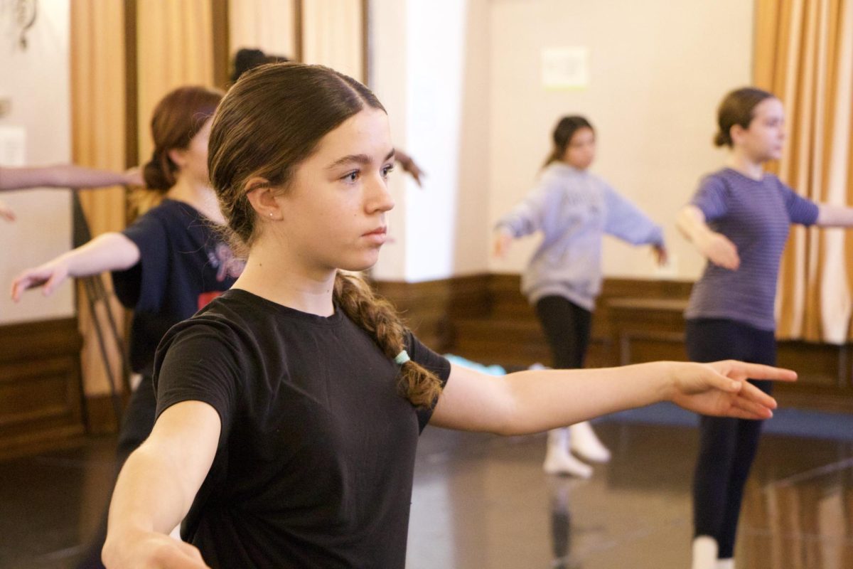 Members of the seventh grade dance class stretch together at the beginning of class. As the second semester commenced, students in grades six through eight began new arts electives, allowing them to explore opportunities in sculpture, film, dance and more.