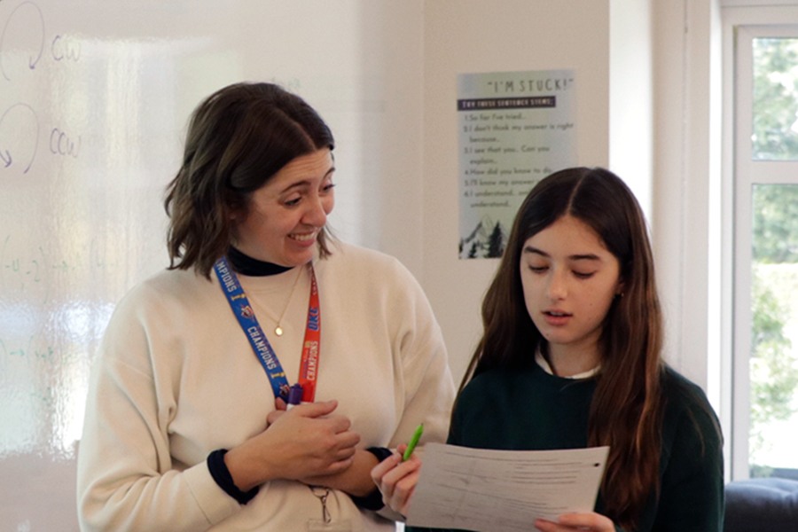 Jillian Faucett helps Kaia Vosicher (‘30)  understand a problem on her worksheet. Vosicher is a student in the Integrated Math I: Accelerated class, where the students are wrapping up their current unit. Faucett said she constantly tries to be a supportive and guiding mentor. “I think [one] of the most important jobs of working with students is just the everyday role model that you become,” Faucett said.